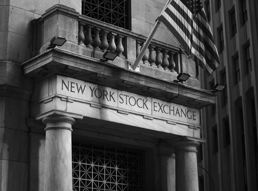 New York Stock Exchange facade with an American flag; illustrative archive photograph.